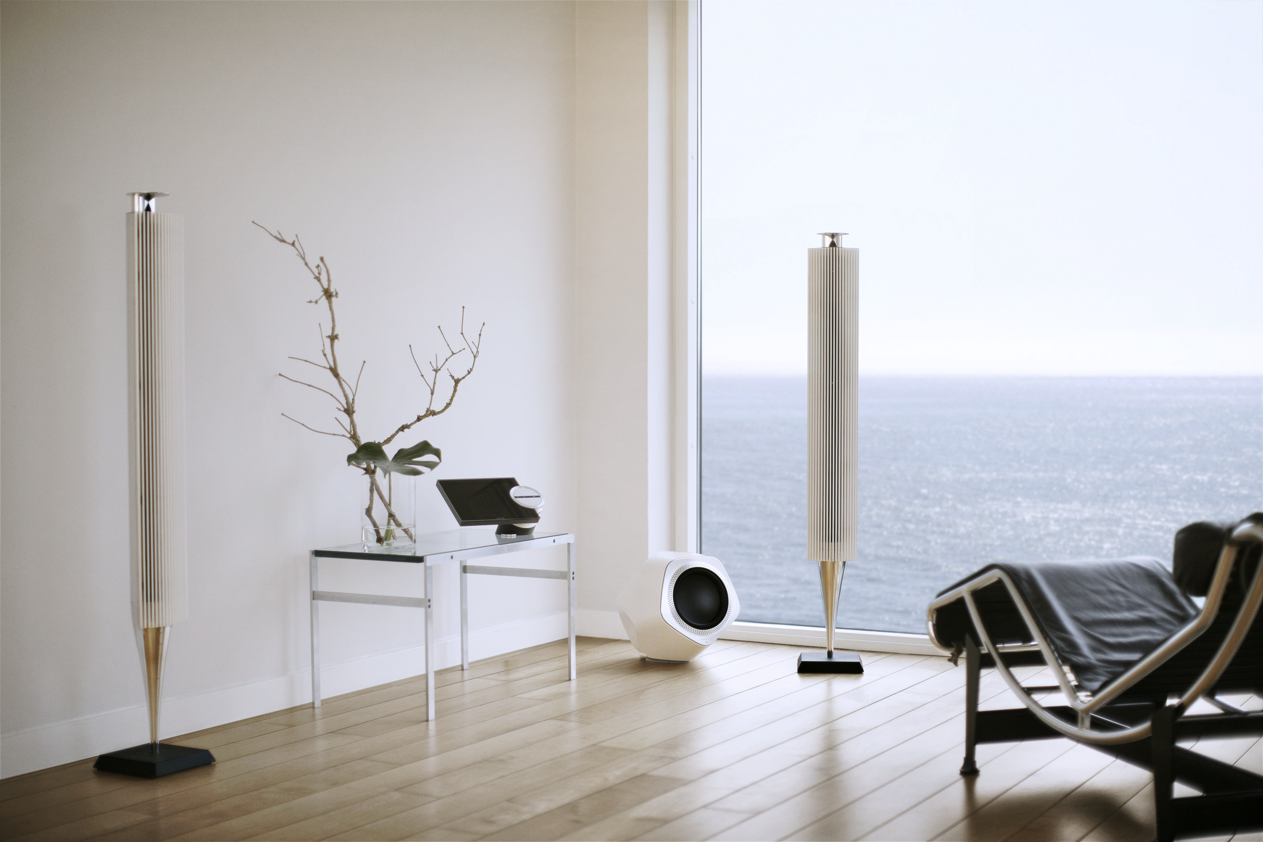A white Beolab 19 paired with a pair of Beolab 18s in an interior